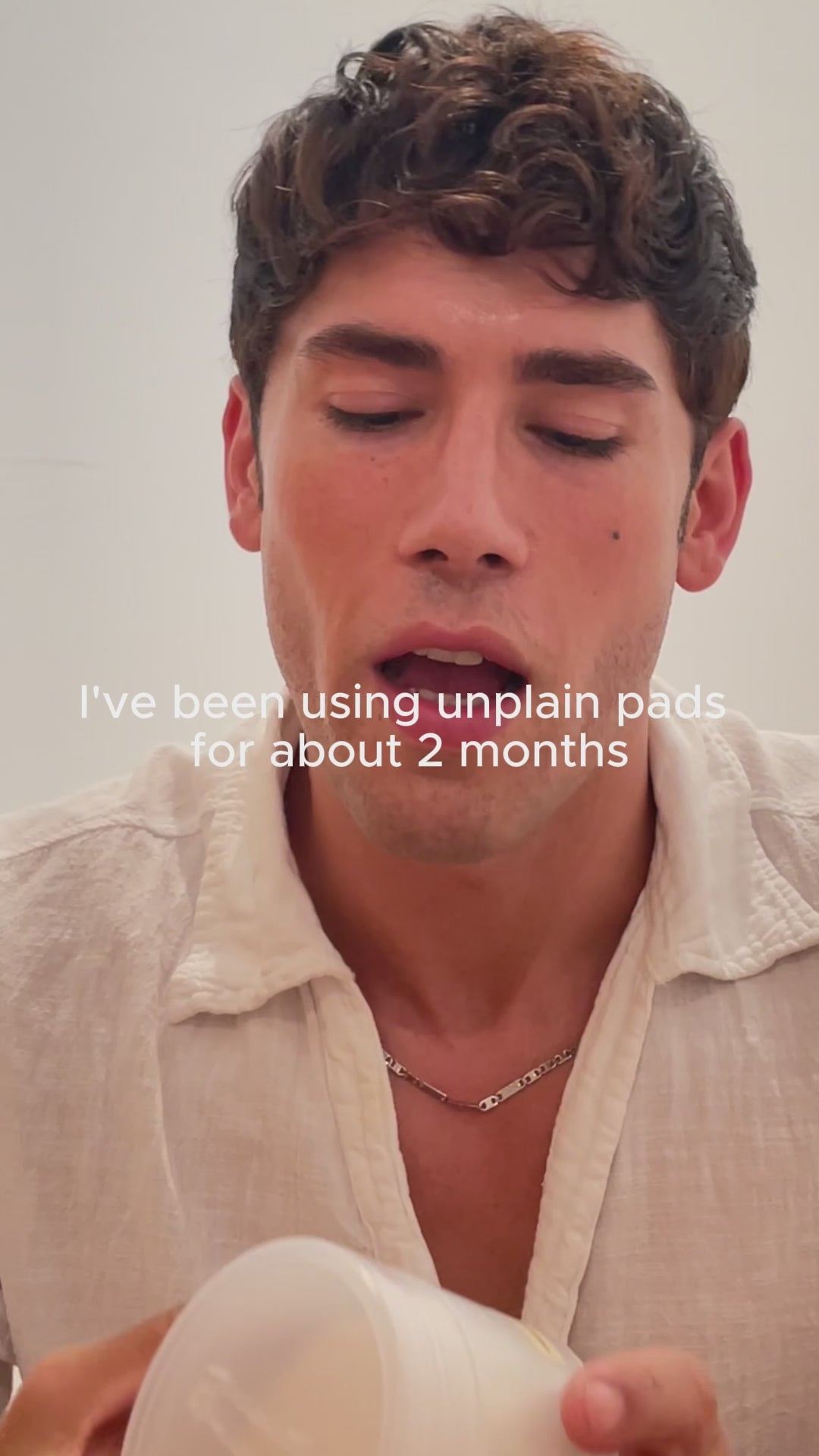 Male influencer using unplain pad to exfoliate skin